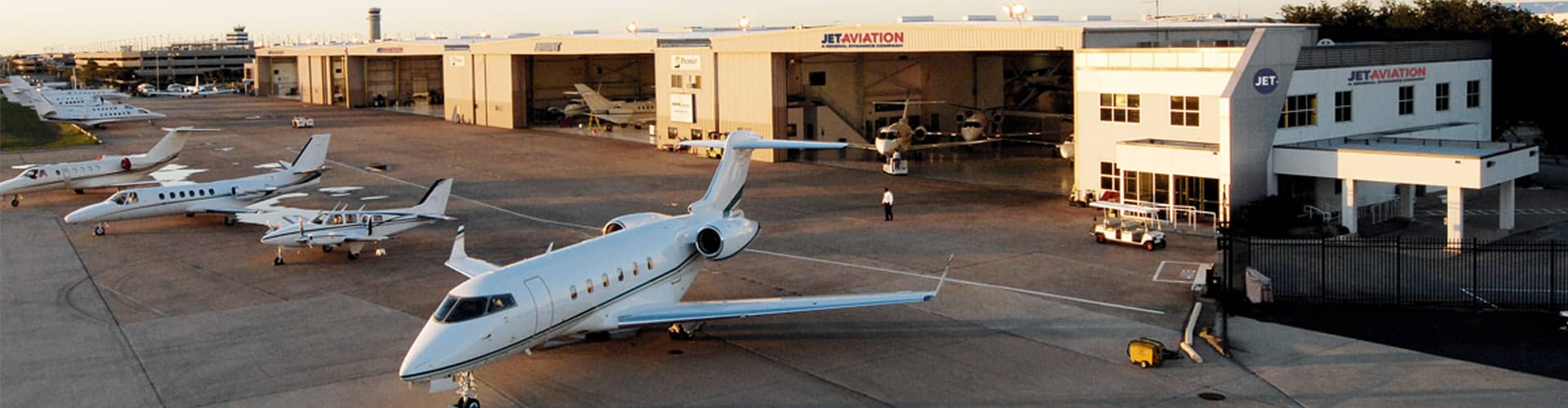 View of planes on the runway and in the hangar