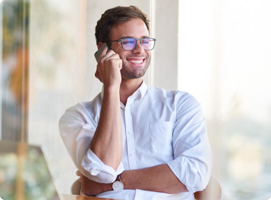 Smiling man talking on the phone