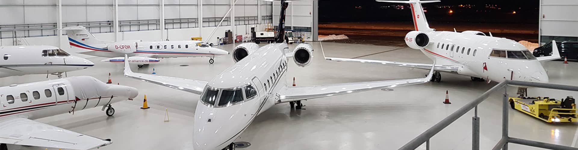 Five white planes in hangar