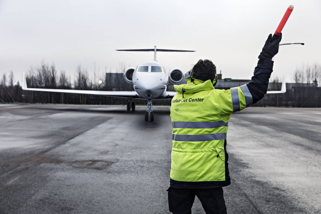 Crew with baton and taxi aircraft