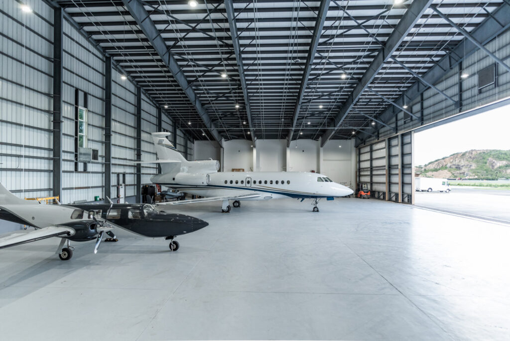 Jet and small plane in hangar
