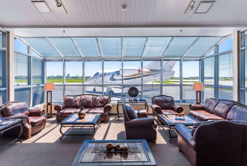 Lobby with sofas and tables with view on the airport