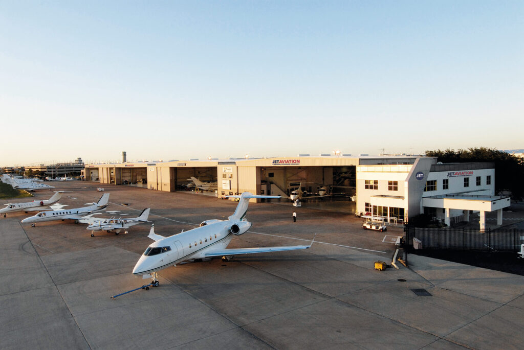 View of planes on the runway and in the hangar