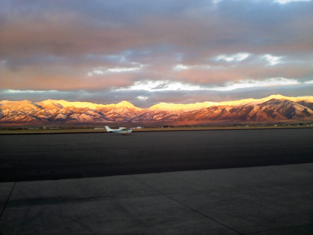 Aviation on ramp with sunset in mountains