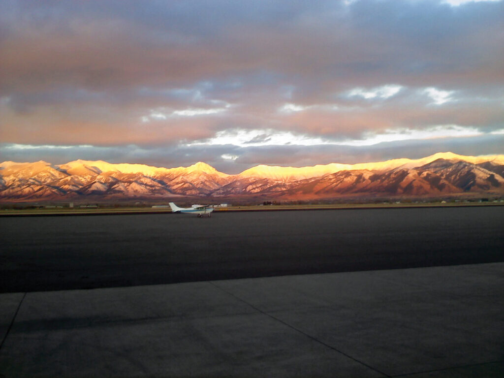 Aviation on ramp with sunset in mountains