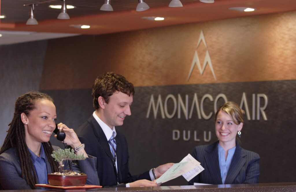 Three people at Monaco Air Duluth reception