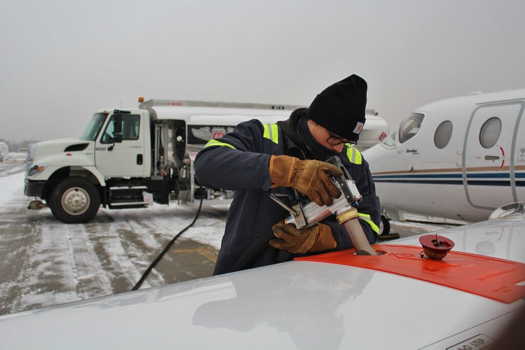 Man from airport service fueling aircraft