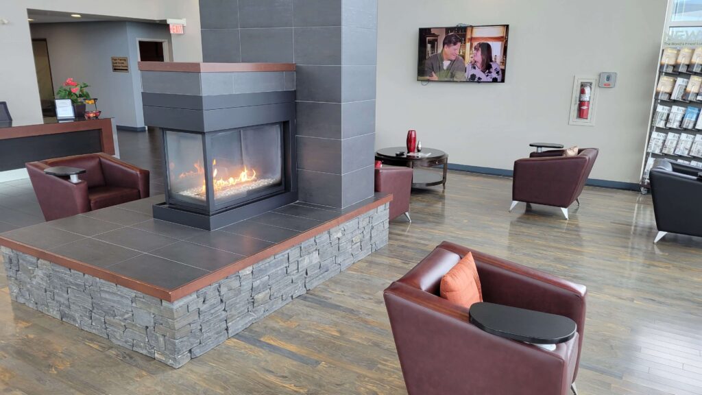 Waiting room with a fireplace and armchairs