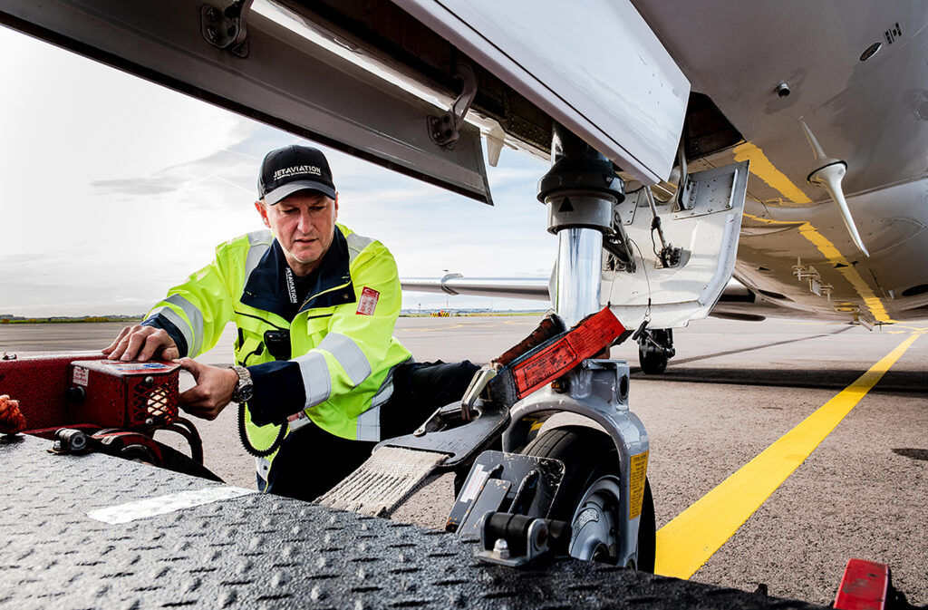 Man attaching light aircraft wheels to the platform