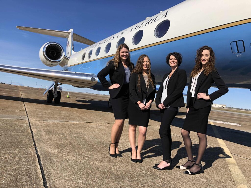 Four stewardesses and plane