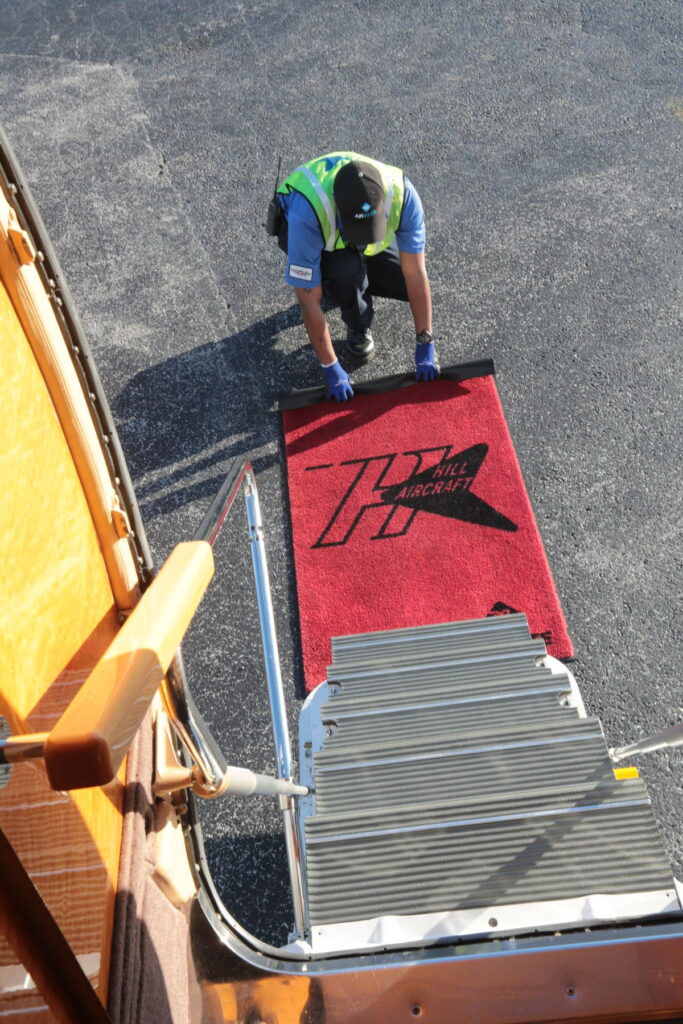 Man spreading out a red carpet