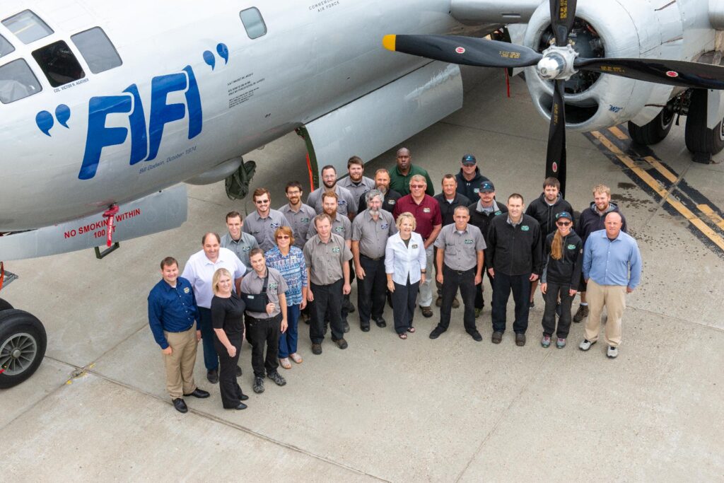 Whole crew standing on the airport near the plane