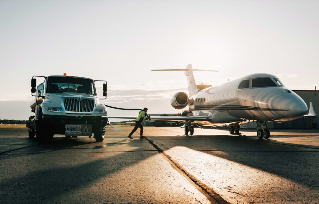 Man pulling a hose for refueling an airplane