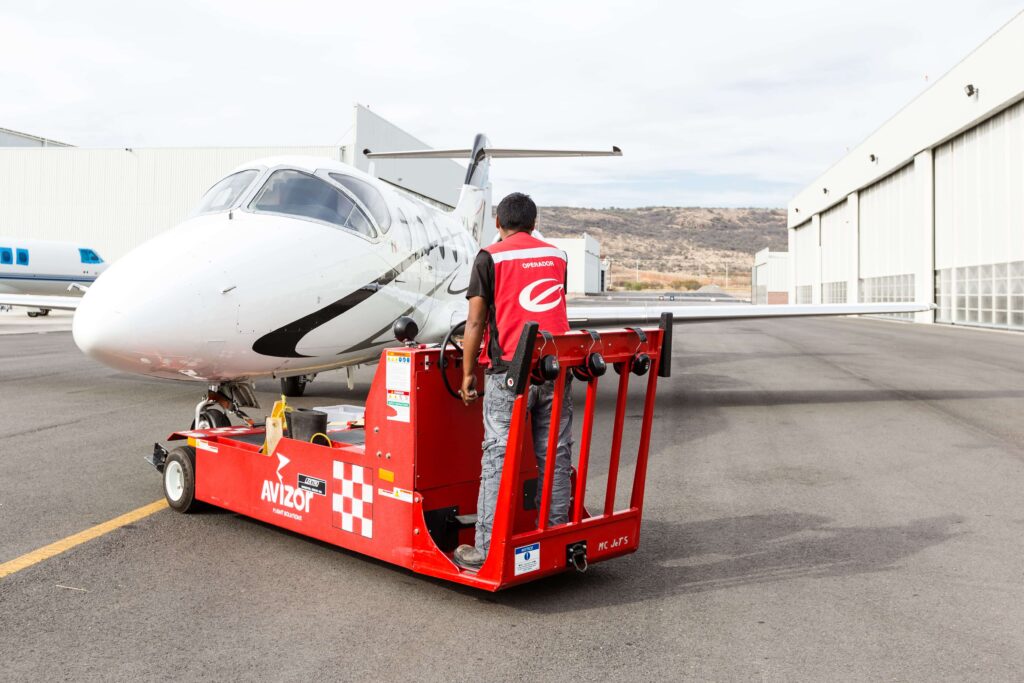 Man pulling the plane with special car