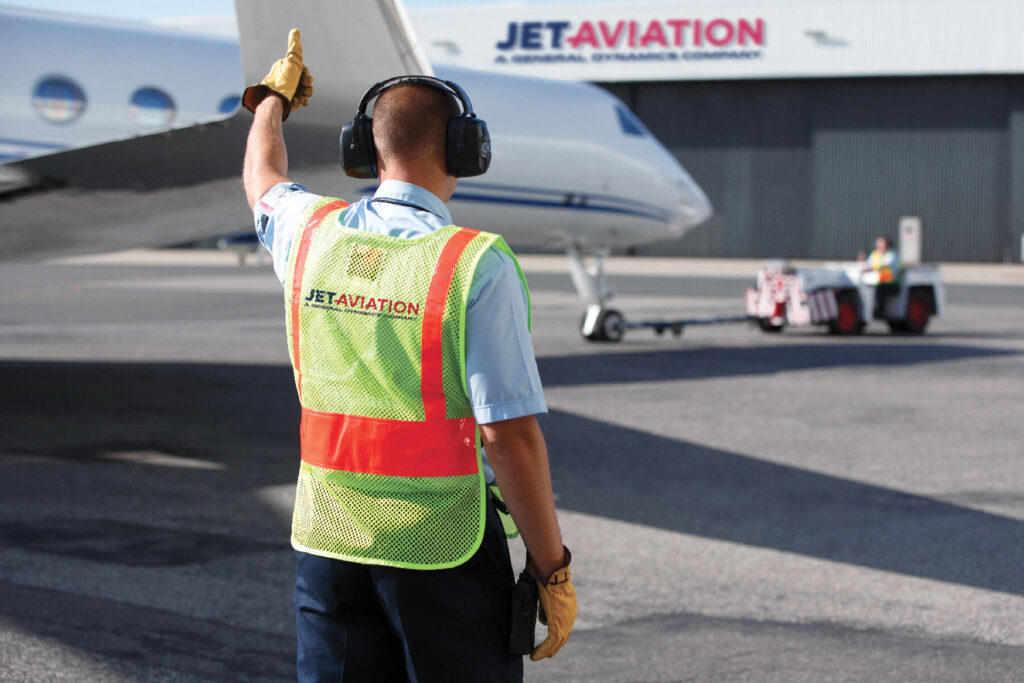 Aviation marshalling give signals to the pilot
