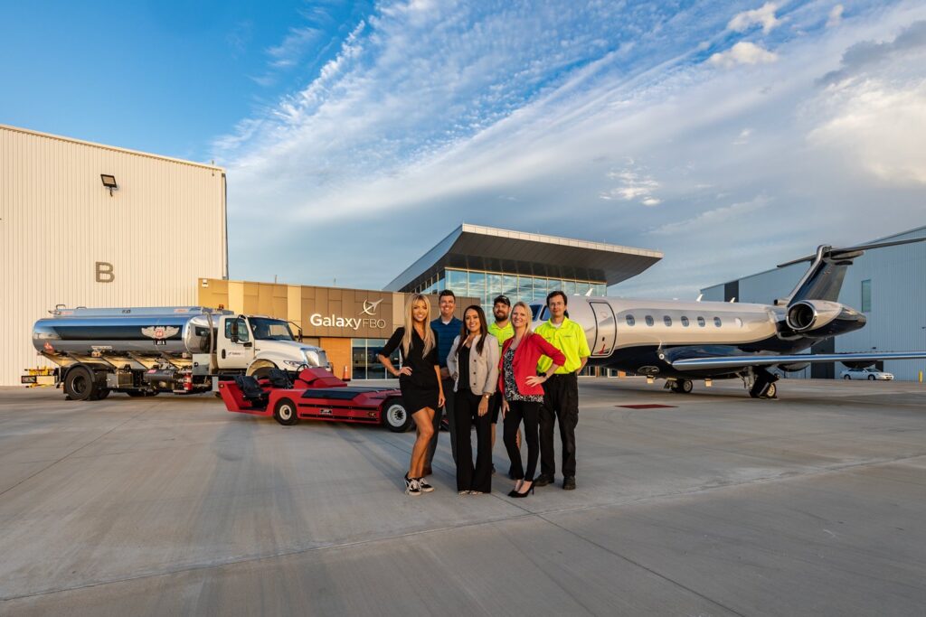 Crew standing on in front of the airplane