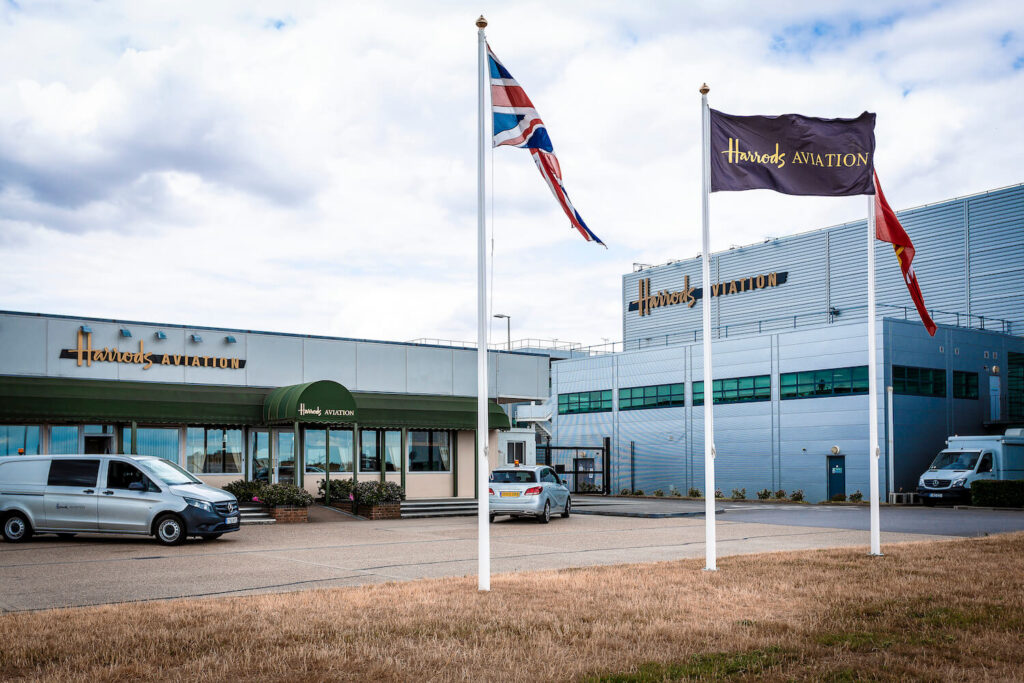 Flags on poles in front of the Harrods Stansted airport