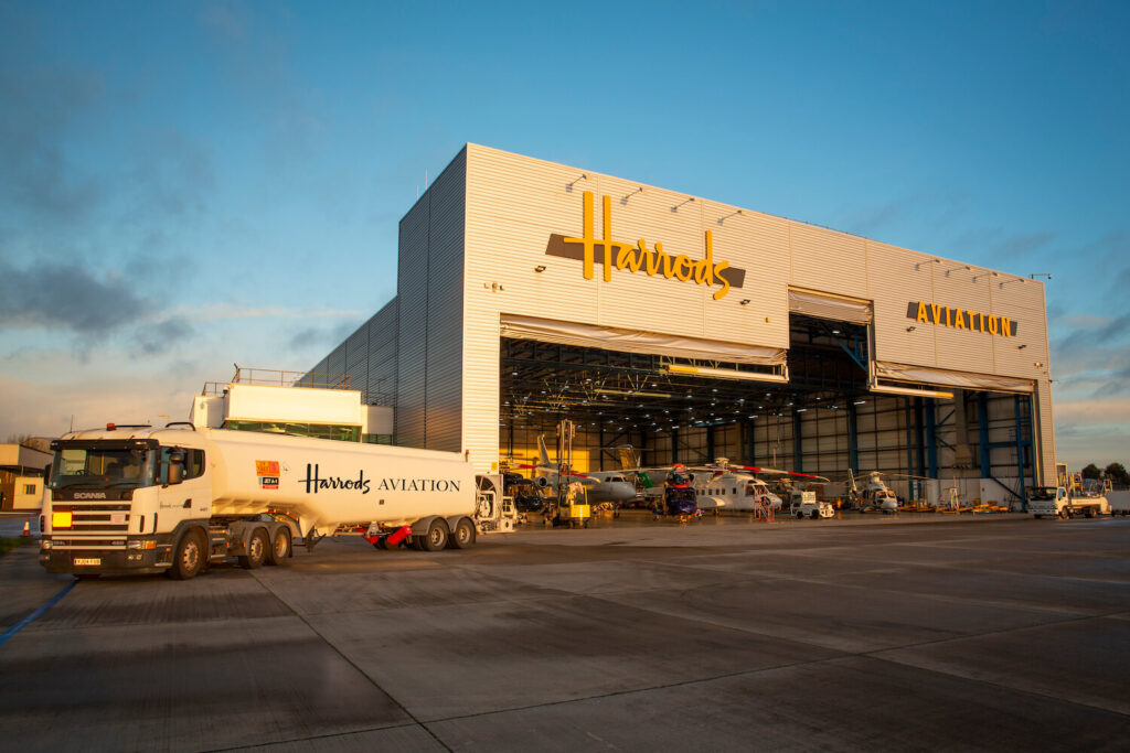 A fuel truck in front of the Harrods Aviation hangar