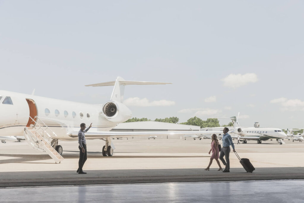 The couple heads to the plane and is greeted by the staff