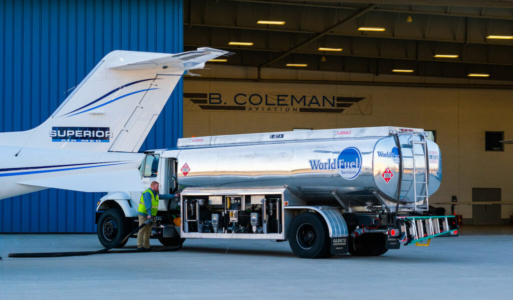 Refueling the plane in front of the hangar