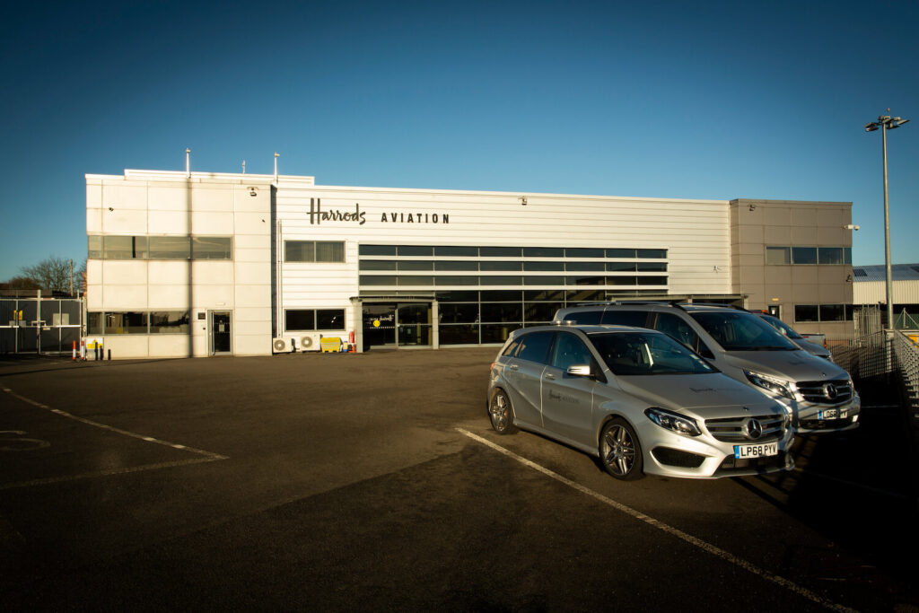 Cars in front of the Harrods Aviation hangar